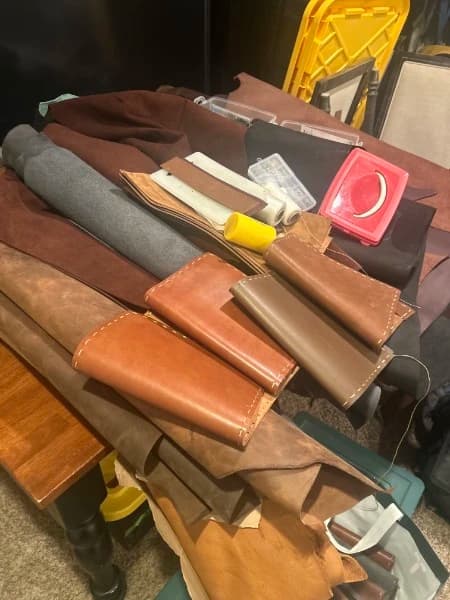 Ben Fowler's leather working bench with hides and journals